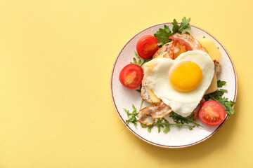 Plate with tasty fried egg, toast, bacon, tomatoes and arugula on beige background