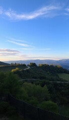 Fototapeta premium a winding road in the mountains with a fence landscape view