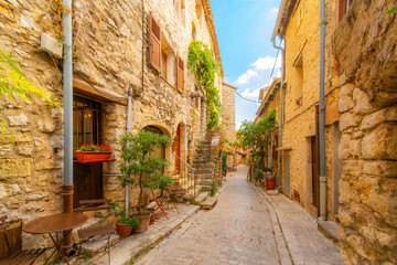 A long, narrow cobblestone alley in the medieval hilltop village of Tourrettes-sur-Loop, France, in...