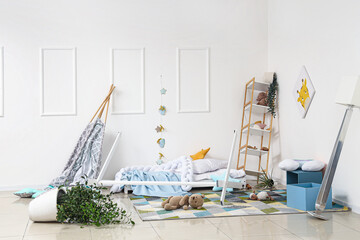Interior of messy children's room with broken bed and shelf unit