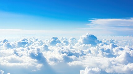Fototapeta premium Breathtaking Aerial View of Fluffy Clouds Under a Clear Blue Sky