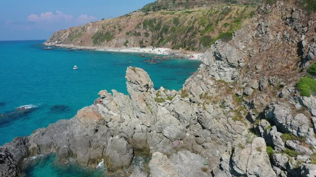 Aerial view of sea and rocky beach in Marinella Di Zambrone on a sunny summer day in Calabria, Italy