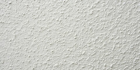 Obraz premium White textured stucco wall background with a subtle pattern of small bumps and a slightly rough surface