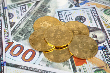 Close-up view of bitcoin coins and dollar bills. The virtual currency of the future.