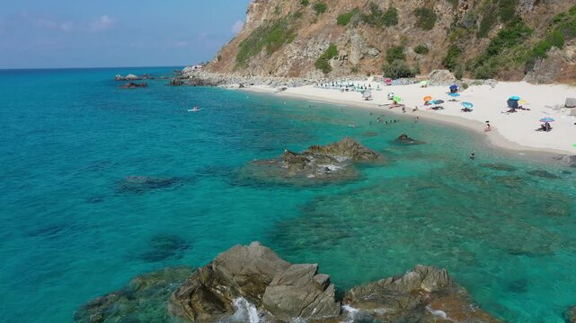 Aerial view of sea and rocky beach in Marinella Di Zambrone on a sunny summer day in Calabria, Italy