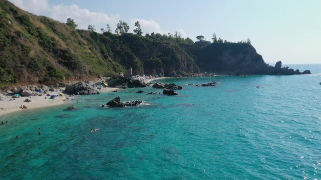 Aerial view of sea and rocky beach in Marinella Di Zambrone on a sunny summer day in Calabria, Italy
