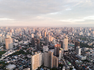 Bangkok aerial panoramic view from the Sukhumvit district at sunrise with cloudy sky. A large asian capital city with skyscrapers and millions of inhabitants