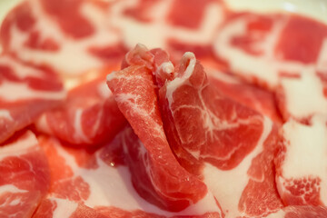 Close-up of raw marbled beef with sauce, perfect for culinary enthusiasts.