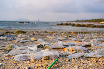 Trash, plastic cups and plastic bags at the beach. environmental problem concept and healing the world
