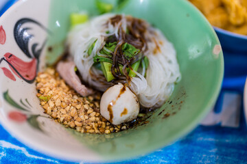 Pork dry noodle is a delicious dish consisting of cooked noodles, typically thin or flat, served without soup and topped with savory slices of pork