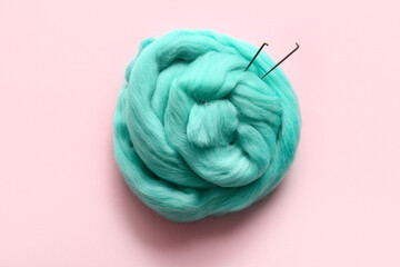 Wool for felting with needles on pink background © Pixel-Shot
