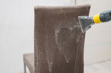 Dry cleaning the back of a fabric chair. 