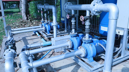 Pump and motor. Close up of water pump station with automatic water control pipe for supplying...