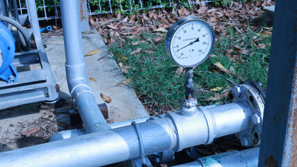 Water pressure gauge on pipe. Water pressure gauge in psi with valve installed on water pipe on...