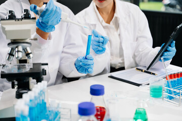 Modern medical research laboratory. female scientist hands working with micro pipettes analyzing...