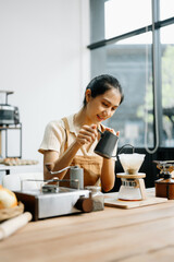 Asian barista brewing fresh espresso. Enjoy a cozy, trendy cafe experience with high quality beans in home or cafe