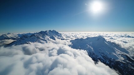 Fototapeta premium Snowy Mountain Peaks Above the Clouds: A breathtaking aerial view of snow-capped mountain peaks piercing through a vast sea of clouds, bathed in the golden glow of the sun.