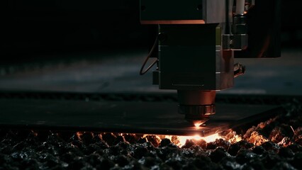 Plasma cutting of metal with a cnc. A plasma cutter cuts a workpiece from a sheet of metal. Laser...