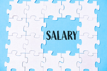 A jigsaw puzzle with the word salary written in the middle