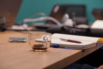 glass cup of  coffee with pen and notebook in conference office