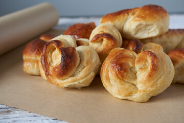 Freshly baked buns on a baking sheet. Selective focus.