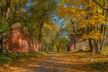 Golden autumn at the entrance to the ancient Gdov fortress