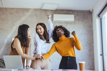 Diverse Group of Women Celebrating a Successful Team Collaboration