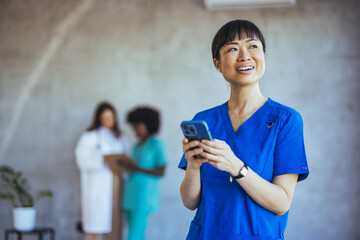 Smiling Healthcare Professional Using Smartphone in Hospital Setting