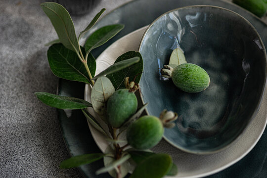 Autumnal table setting with fresh feijoa fruits
