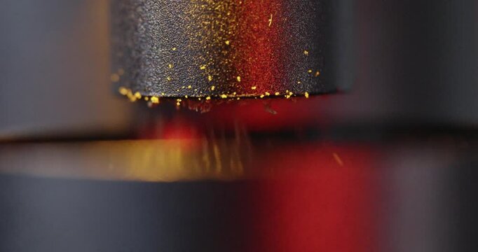 Closeup, slow motion shot of professional coffee grinder griding freshly roasted coffee at high speed