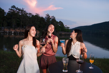 Asian women celebrating, meeting and chatting in a bar. Places to visit, beautiful lights