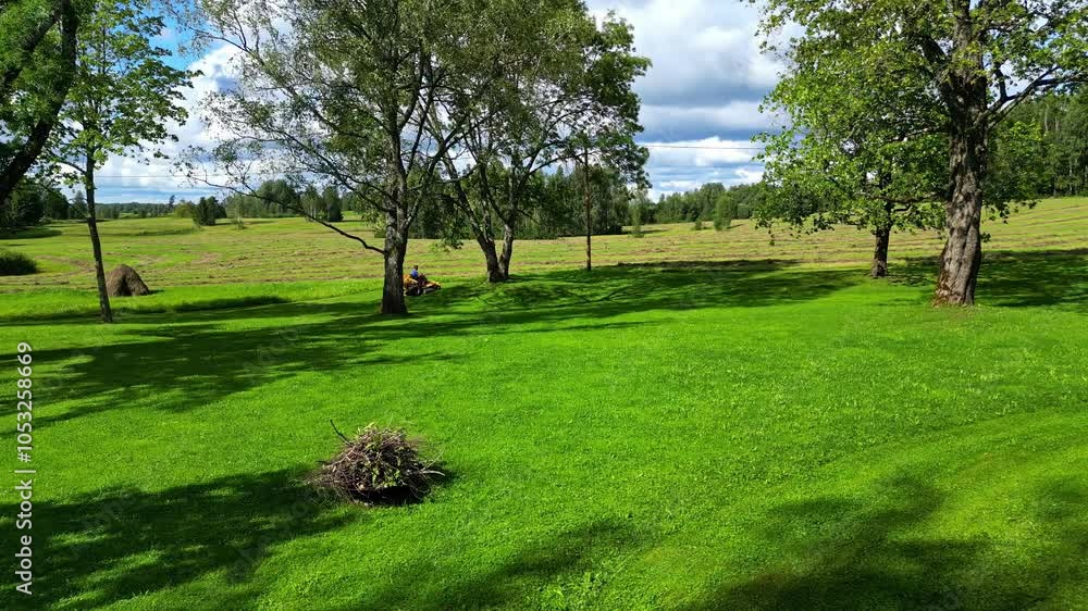 Aufkleber forward moving drone view of a beautiful green land with few trees and forest at background during d