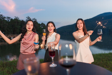 Asian women celebrating, meeting and chatting in a bar. Places to visit, beautiful lights