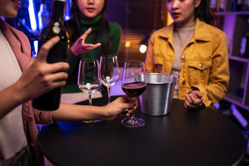 Asian women celebrating, meeting and chatting in a bar. Places to visit, beautiful lights
