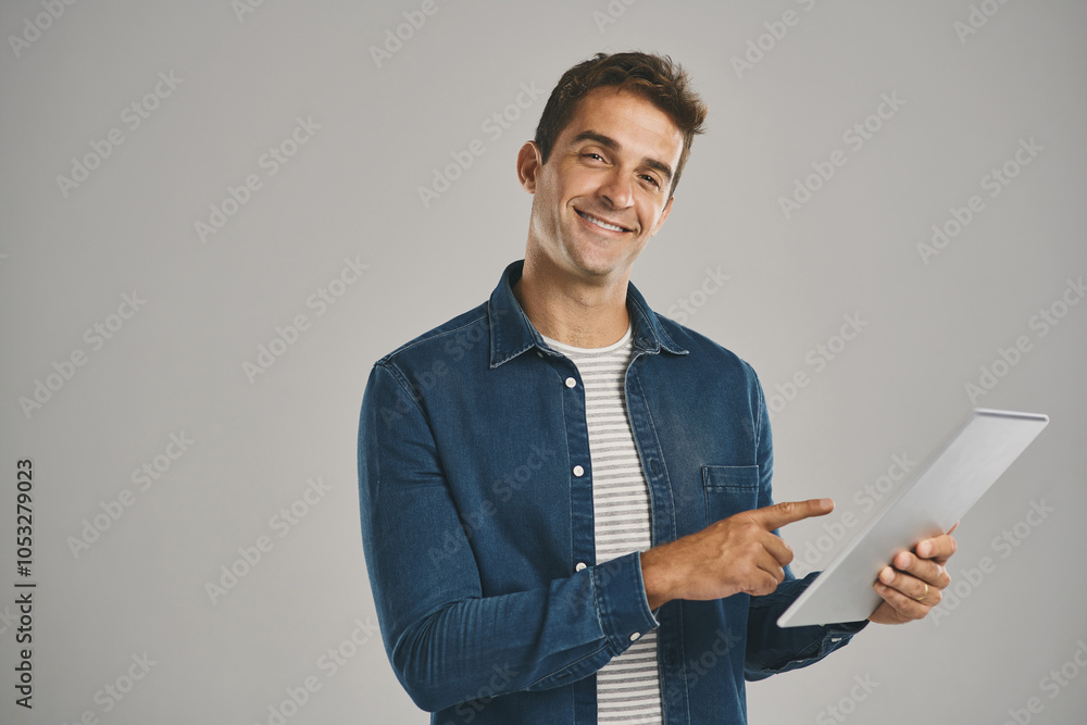 Poster pointing, portrait and tablet with man in studio isolated on gray background for app download or upd