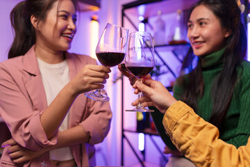 Asian women celebrating, meeting and chatting in a bar. Places to visit, beautiful lights