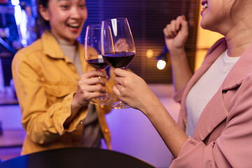 Asian women celebrating, meeting and chatting in a bar. Places to visit, beautiful lights