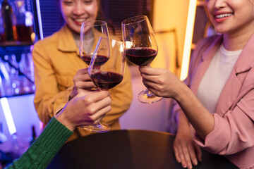 Asian women celebrating, meeting and chatting in a bar. Places to visit, beautiful lights