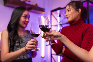 Asian women celebrating, meeting and chatting in a bar. Places to visit, beautiful lights