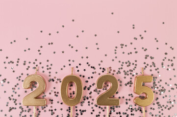 2025 Happy New Year. Top view of gold numbers, silver stars confetti on pink background. Copy...