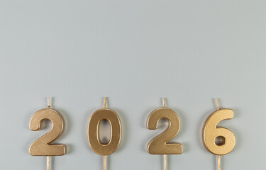 2026 Happy New Year. Top view of gold numbers on grey background. Copy space, flat lay.