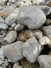 A picture of some rocks by the river, beautiful if made as a wall or fence of a house