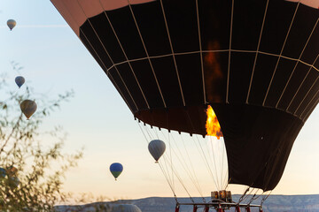 Three colorful hot air balloons are gracefully flying high in the sky