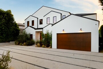 Modern white house with wooden garage.