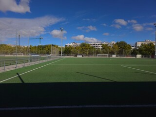 Fototapeta premium Sunlit Football Field with Clear Blue Skies