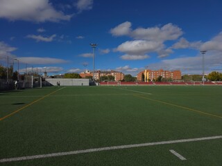 Empty Football Field Under a Clear Blue Sky
