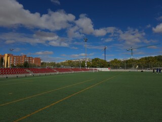 Quiet Football Stadium with Red Seats on a Sunny Day