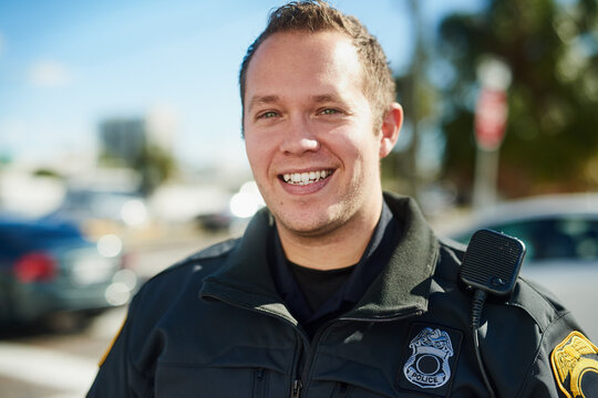 Man, portrait and police officer on duty, outdoor and uniform for responsibility in urban city. Male person, law enforcement and cop for public service of security, fearless and authority in traffic