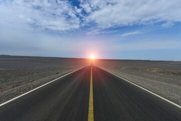 Fototapeta premium Desert road sand dunes in Xinjiang, China