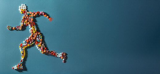 Running human figure made from pills